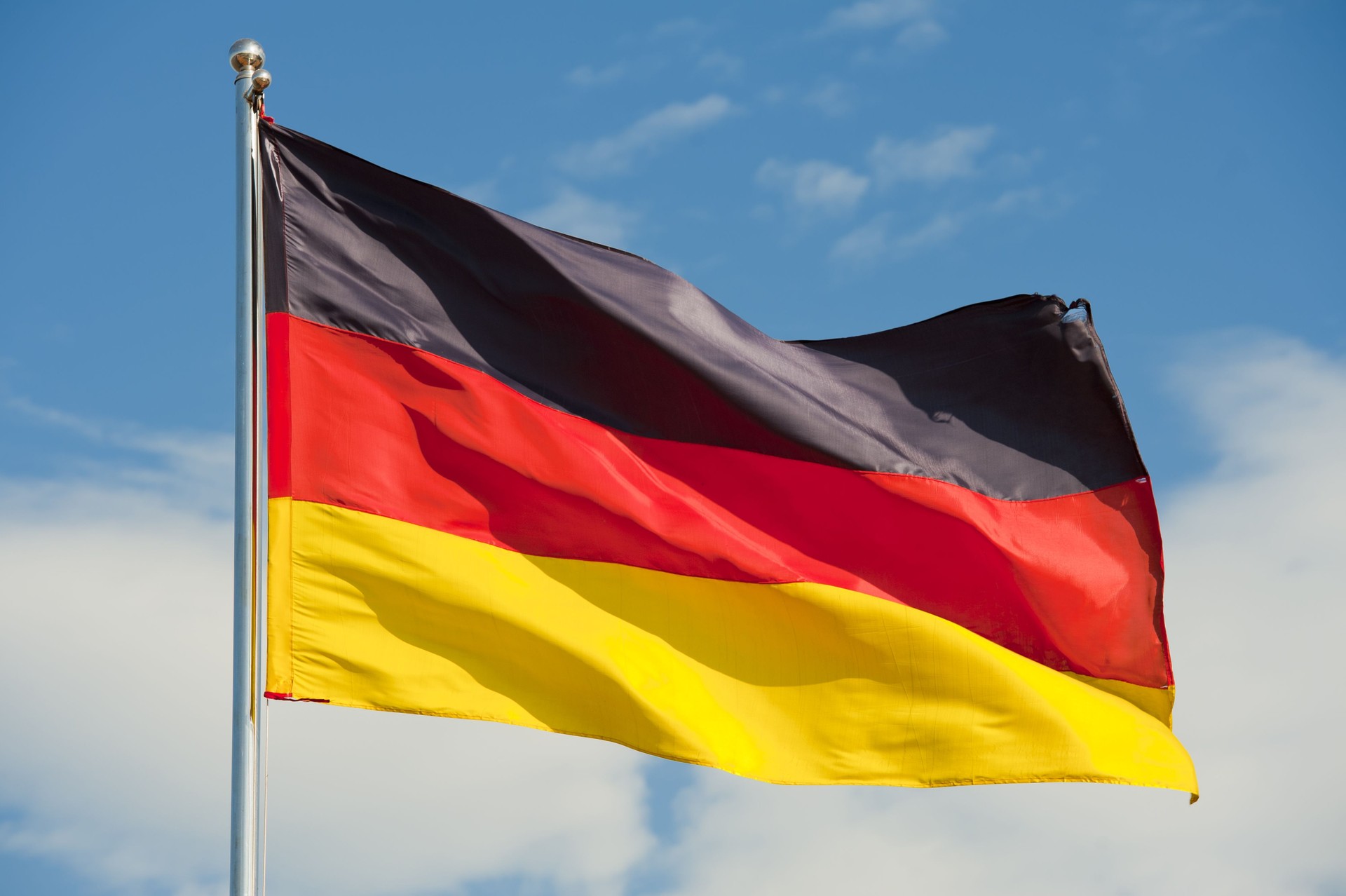 Flag of Germany flying on top of flag pole