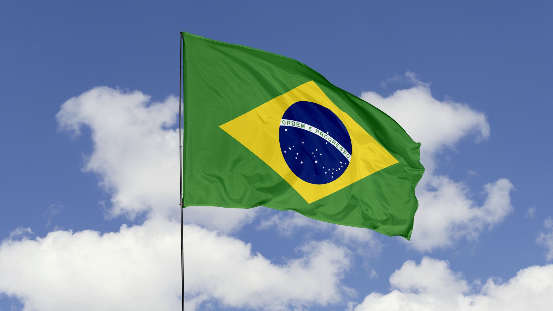 Brazil Flag is Waving Against in the Sky.